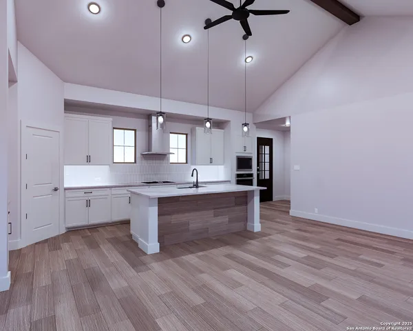 a large kitchen with a wooden floor and outdoor space
