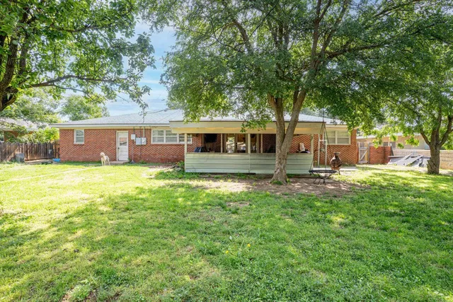 a front view of house with yard and outdoor seating