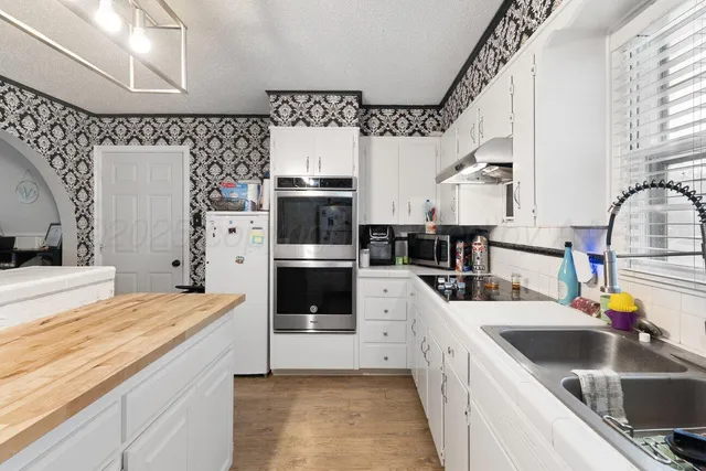 a kitchen with a sink a stove and refrigerator