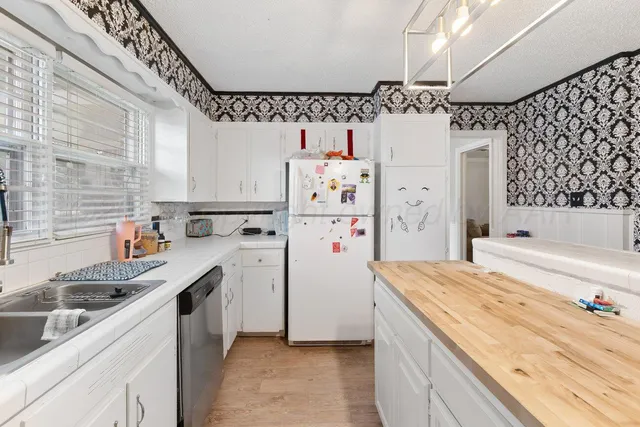 a kitchen with stainless steel appliances kitchen island granite countertop a sink and cabinets
