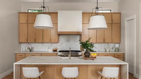 a kitchen with granite countertop a sink a stove and a wooden cabinets