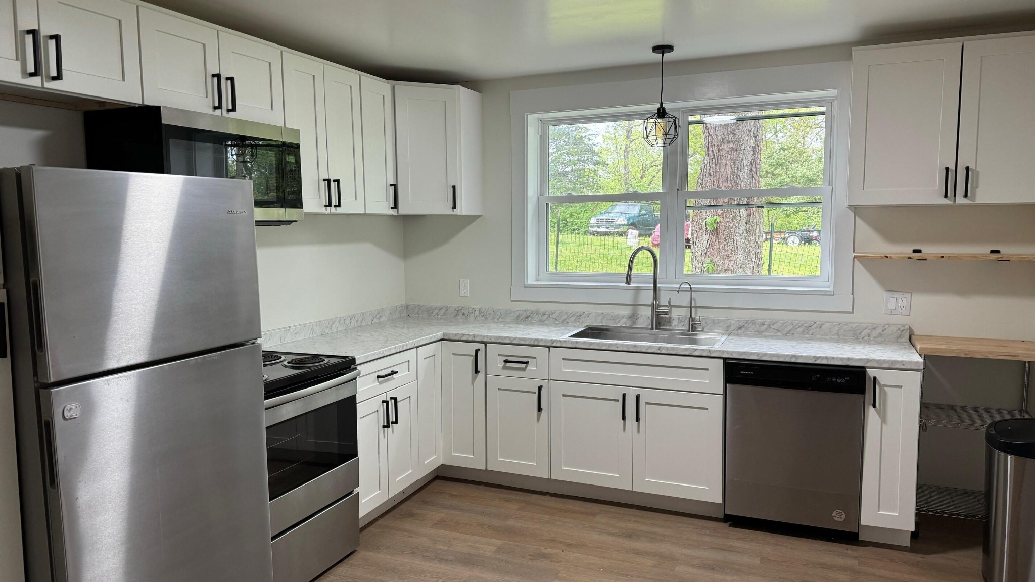 340 Grady Road Etowah, TN 37331 - Photo 14 of 34 a kitchen with stainless steel appliances a white cabinets and a window