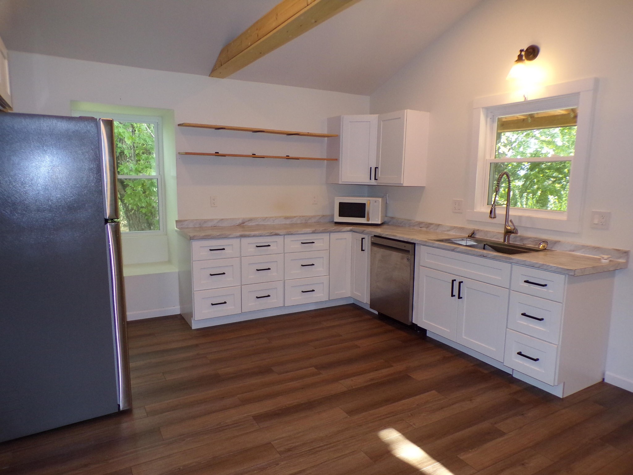 340 Grady Road Etowah, TN 37331 - Photo 26 of 34 a kitchen with stainless steel appliances sink cabinets and wooden floor