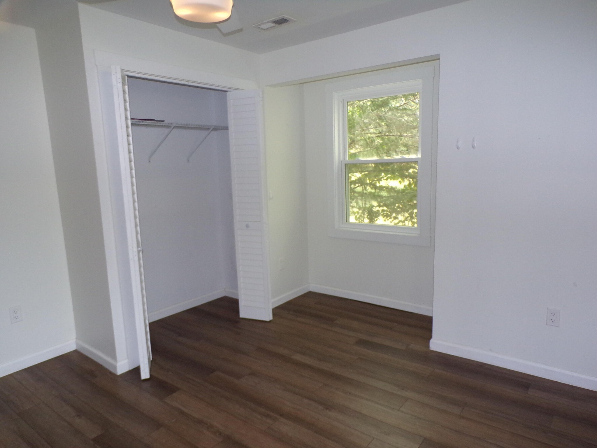 340 Grady Road Etowah, TN 37331 - Photo 31 of 34 an empty room with wooden floor closet and windows