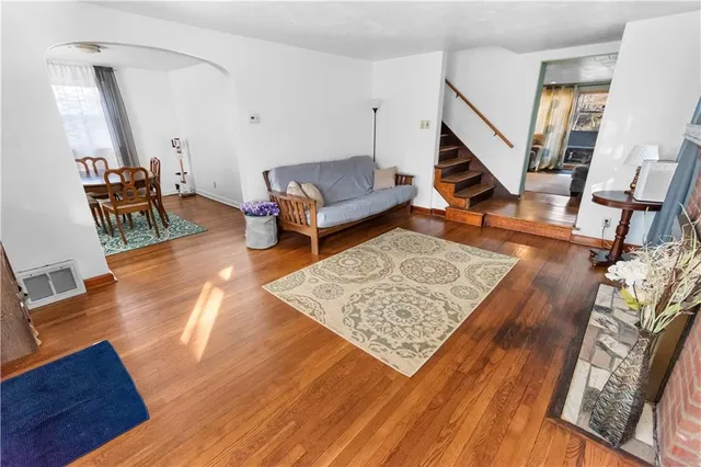 a living room with furniture and a wooden floor