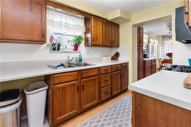 a kitchen with a sink cabinets and window