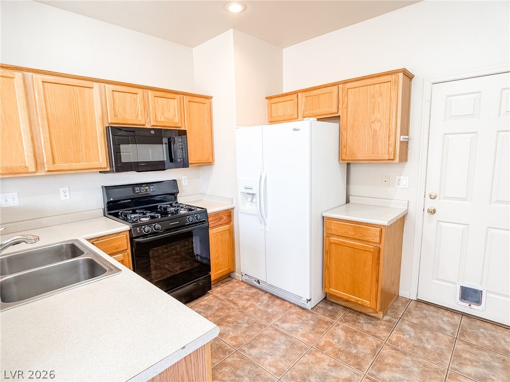 228 Positive Point Street Henderson, NV 89012 - Photo 7 of 27 Functional kitchen with ample cabinetry and essential appliances for everyday culinary tasks.