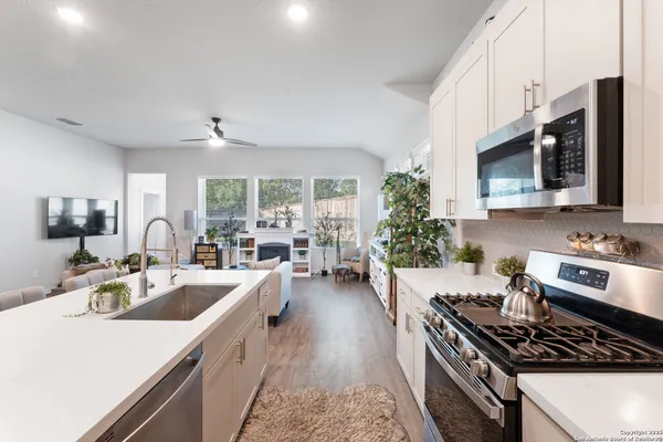 a kitchen with sink stove and cabinets