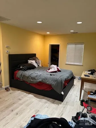 a bedroom with a bed and a mirror