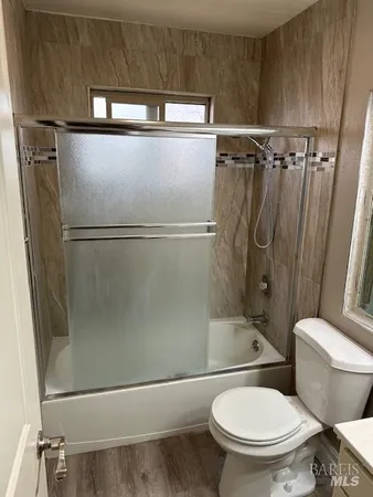 a bathroom with a toilet and a shower