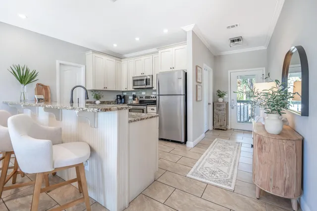 a living room with furniture a flat screen tv and a window