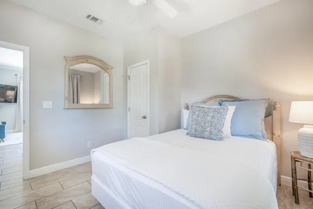 a view of a chair and tables in the back yard of the house