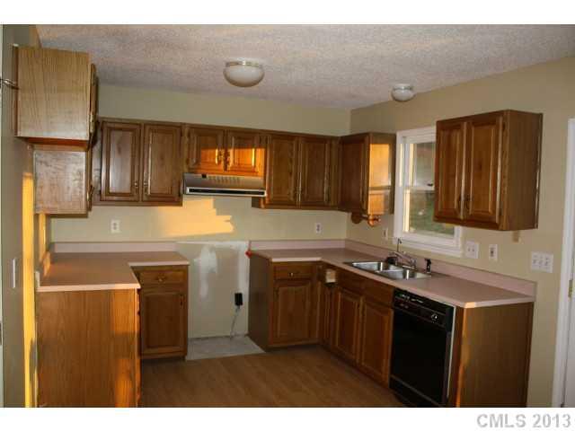 6002 Lanai Lane Tega Cay, SC 29708 - Photo 4 of 16 a kitchen with a sink and cabinets