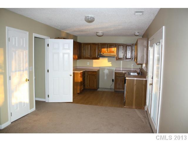 6002 Lanai Lane Tega Cay, SC 29708 - Photo 5 of 16 a kitchen with stainless steel appliances granite countertop a refrigerator a sink a stove with wooden floor