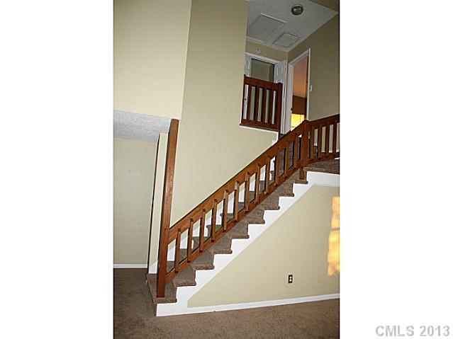 6002 Lanai Lane Tega Cay, SC 29708 - Photo 7 of 16 a view of a hallway with windows and stairs