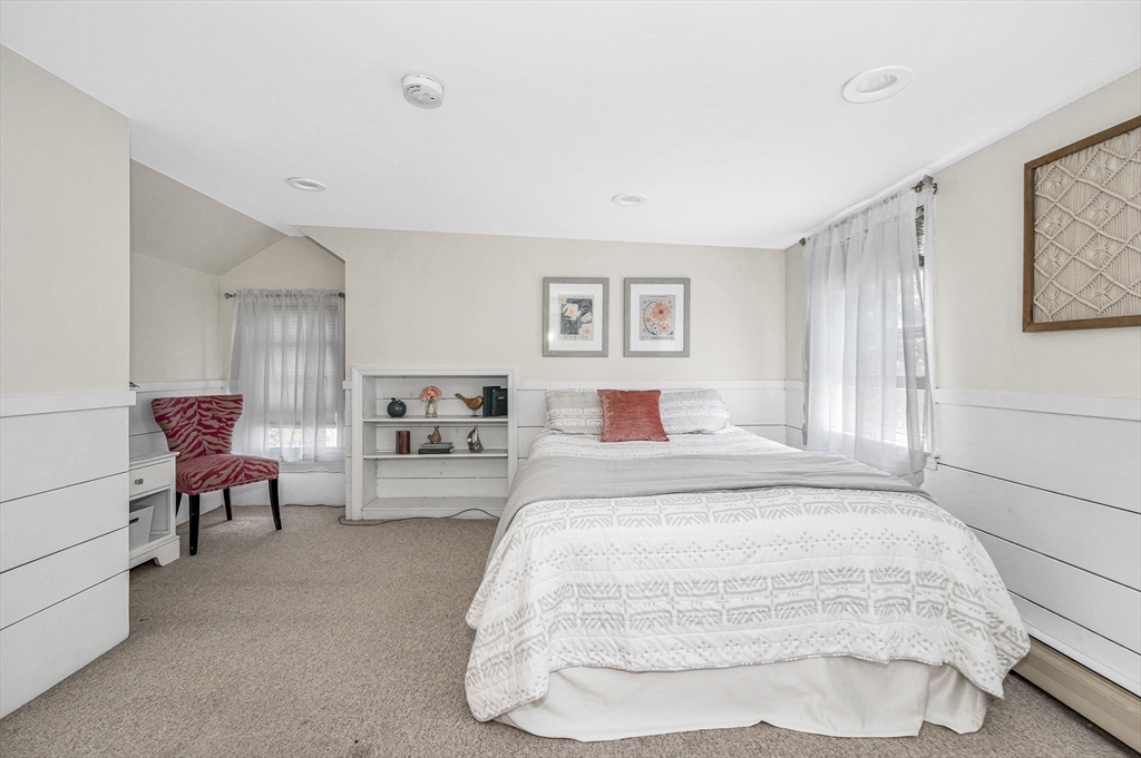 683 Bay Road Hamilton, MA 01982 - Photo 23 of 42 a spacious bedroom with a bed and a couch