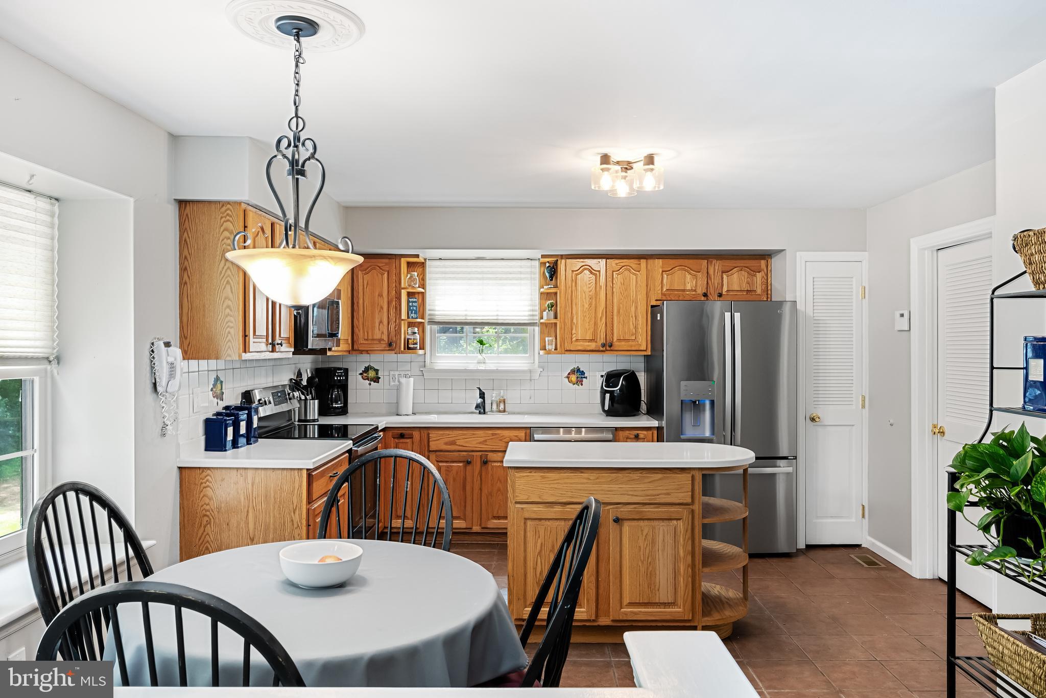 26 Brookview Drive Voorhees, NJ 08043 - Photo 14 of 50 a kitchen that has a table chairs and a refrigerator