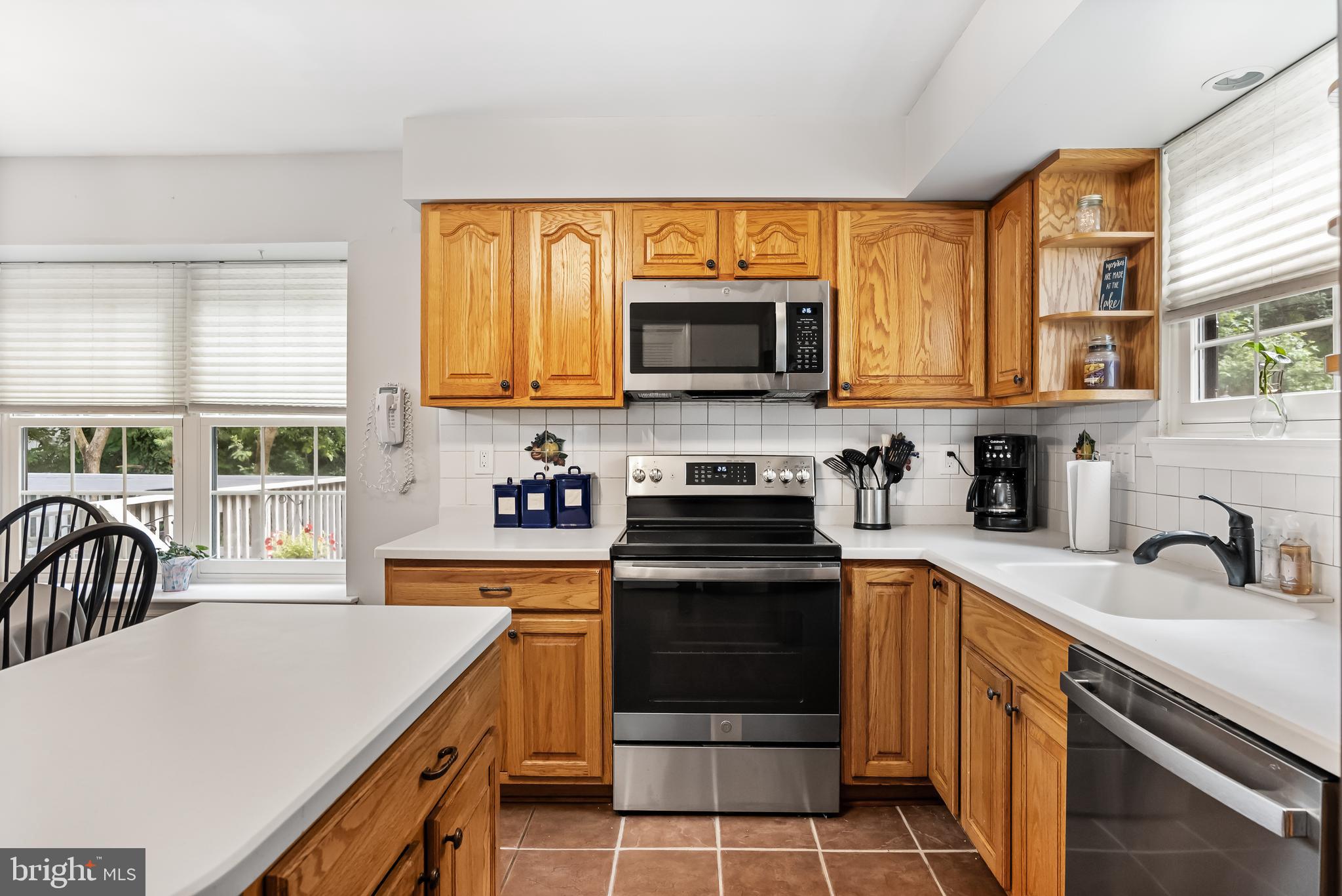 26 Brookview Drive Voorhees, NJ 08043 - Photo 17 of 50 a kitchen with stainless steel appliances a stove sink microwave and cabinets