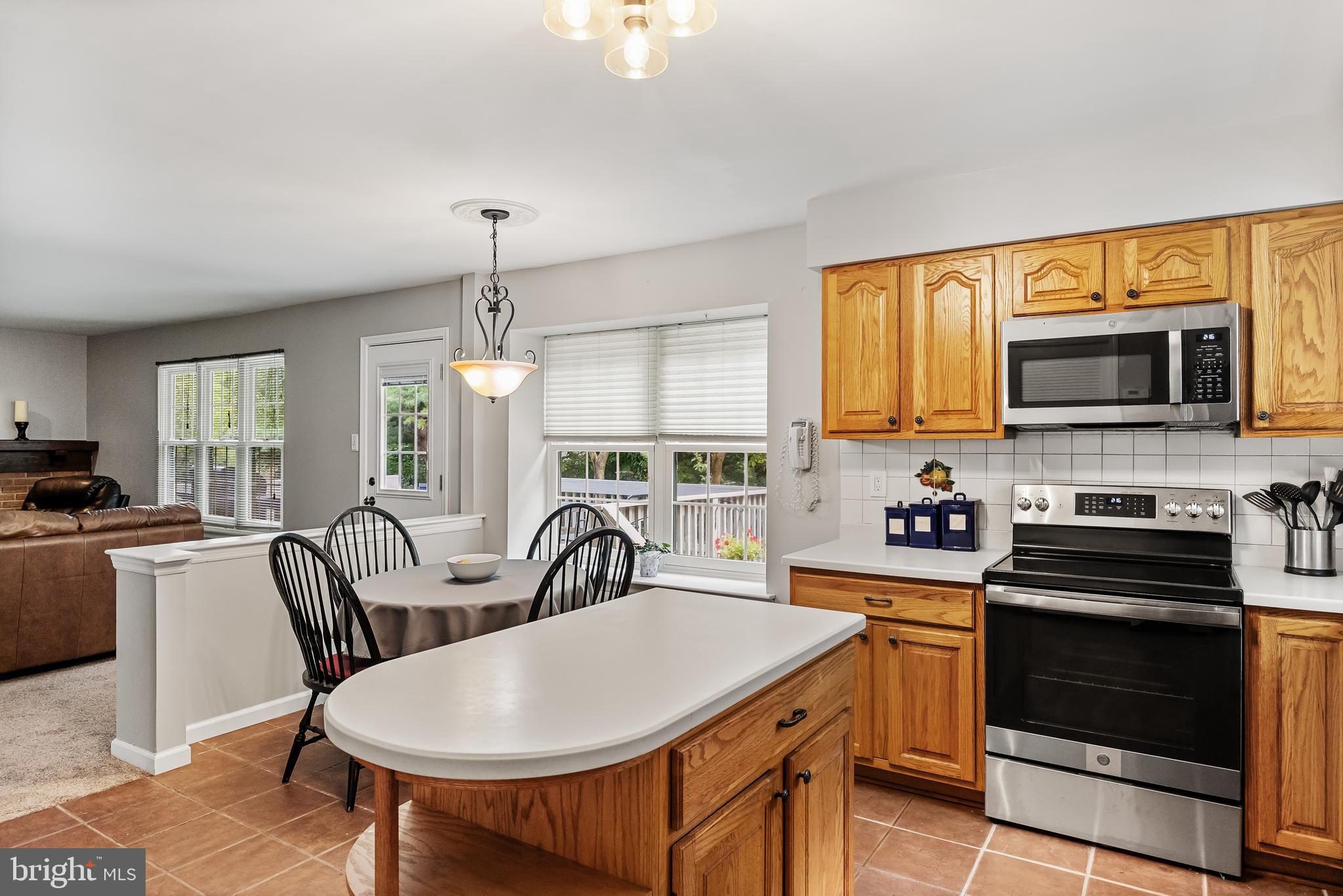 26 Brookview Drive Voorhees, NJ 08043 - Photo 18 of 50 a kitchen with stainless steel appliances a stove a sink a microwave and dining table