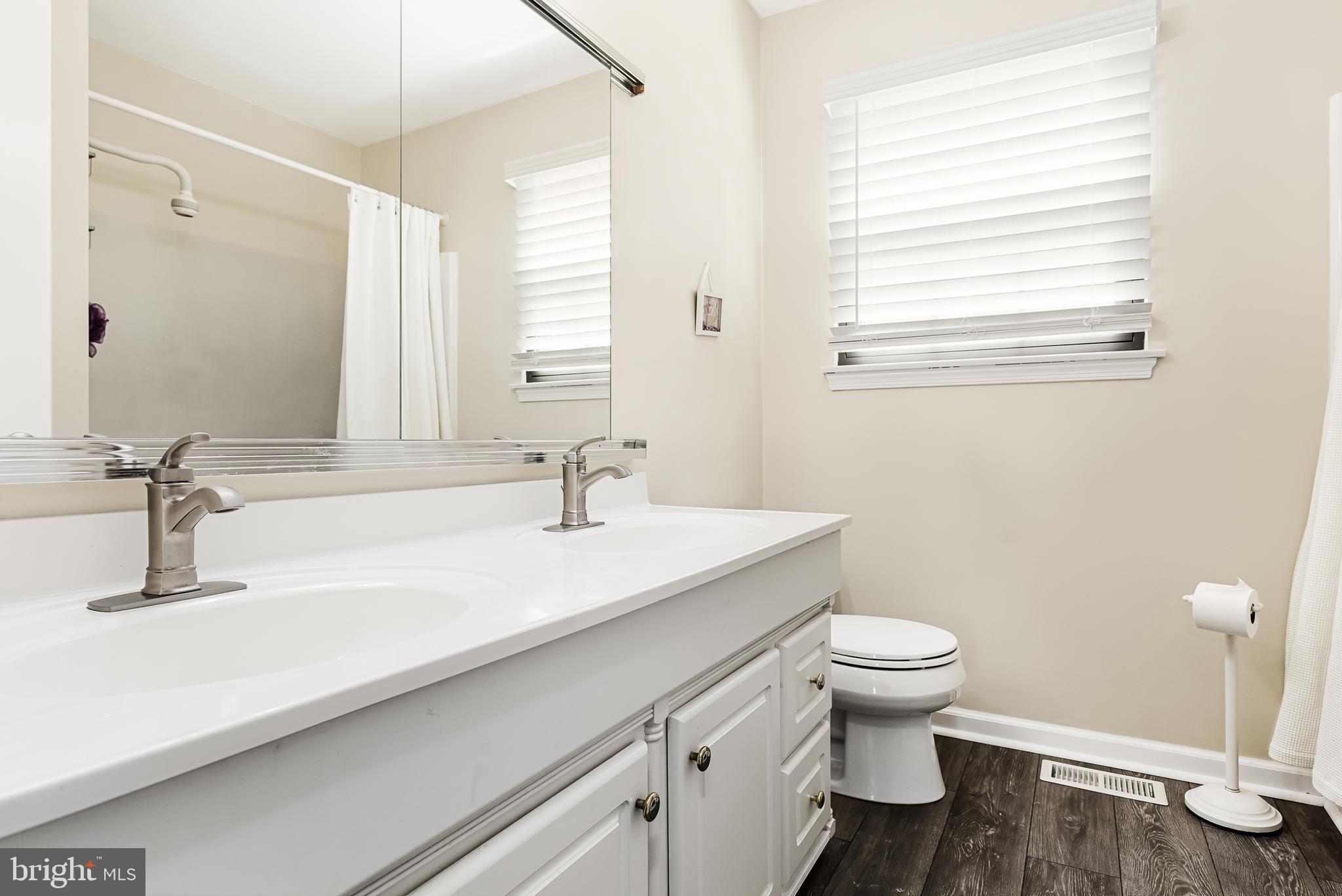 26 Brookview Drive Voorhees, NJ 08043 - Photo 29 of 50 a bathroom with a sink a toilet and a mirror