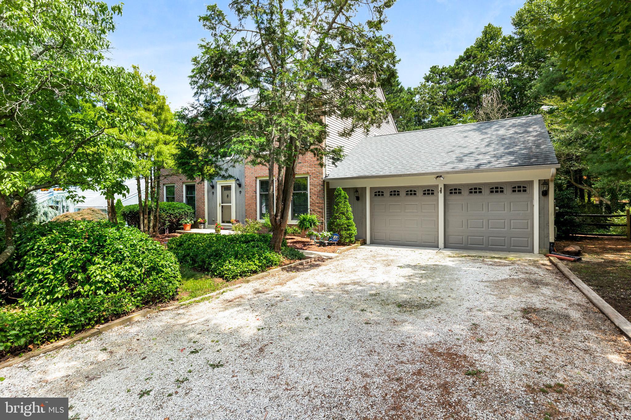 26 Brookview Drive Voorhees, NJ 08043 - Photo 3 of 50 a front view of a house with a garden and trees