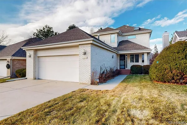 a view of a house with a yard and garage