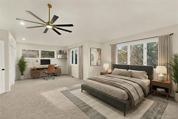 a spacious bedroom with a bed a couch and a window
