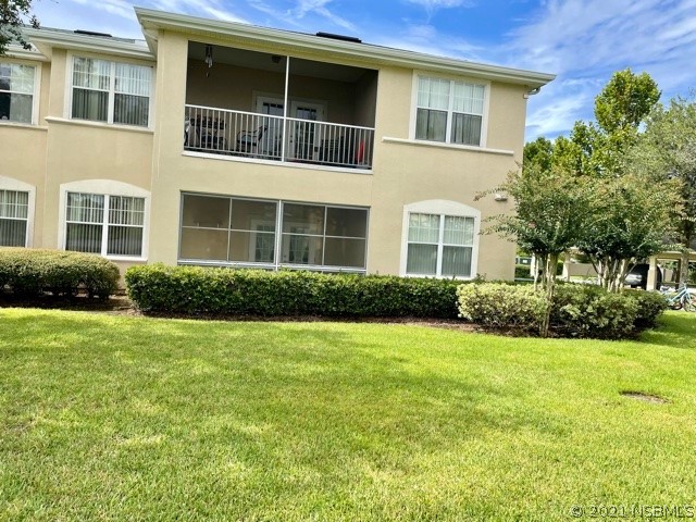 830 Airport Road, Unit 202 Port Orange, FL 32128 - Photo 13 of 35 a front view of a house with garden and trees