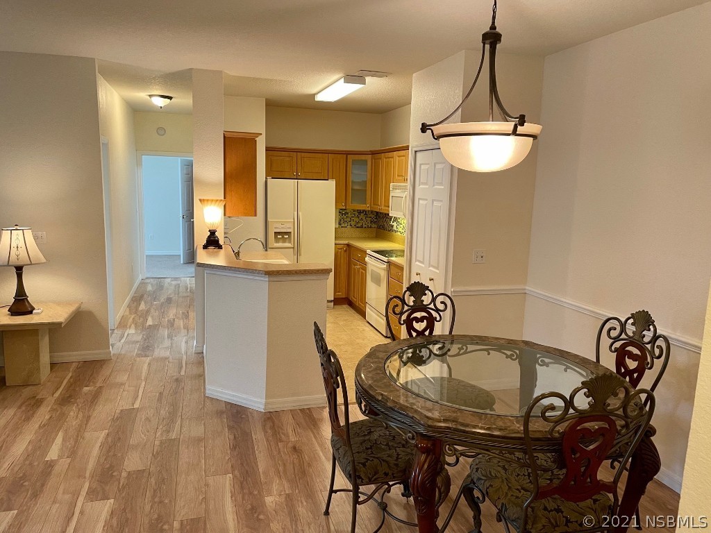 830 Airport Road, Unit 202 Port Orange, FL 32128 - Photo 15 of 35 a view of a dining room with furniture
