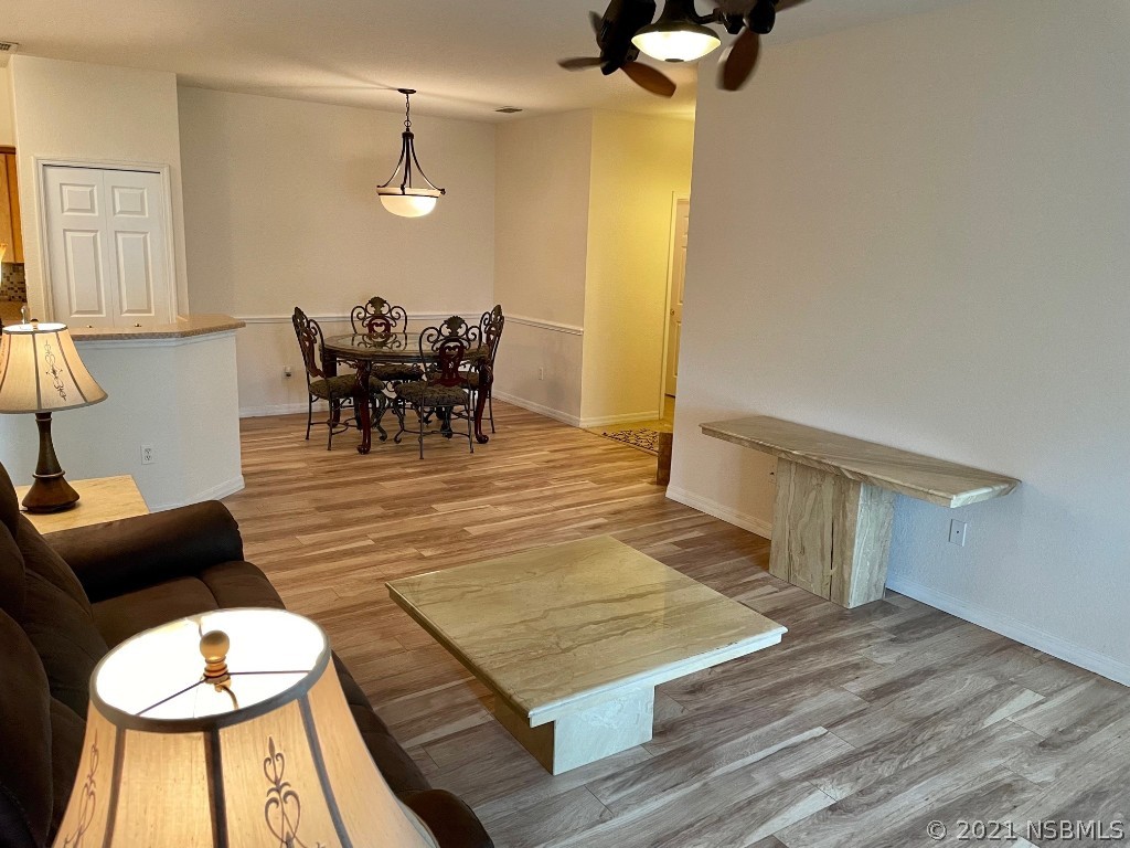 830 Airport Road, Unit 202 Port Orange, FL 32128 - Photo 16 of 35 a view of a dining room with furniture and wooden floor