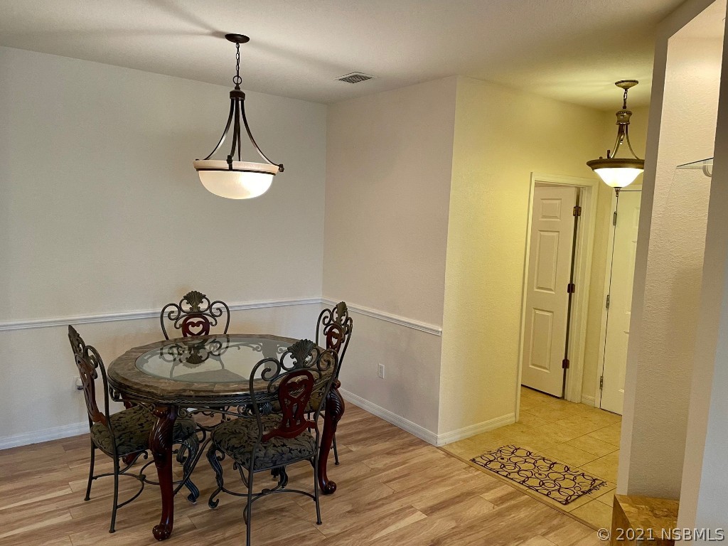 830 Airport Road, Unit 202 Port Orange, FL 32128 - Photo 17 of 35 a view of a dining room with furniture and chandelier