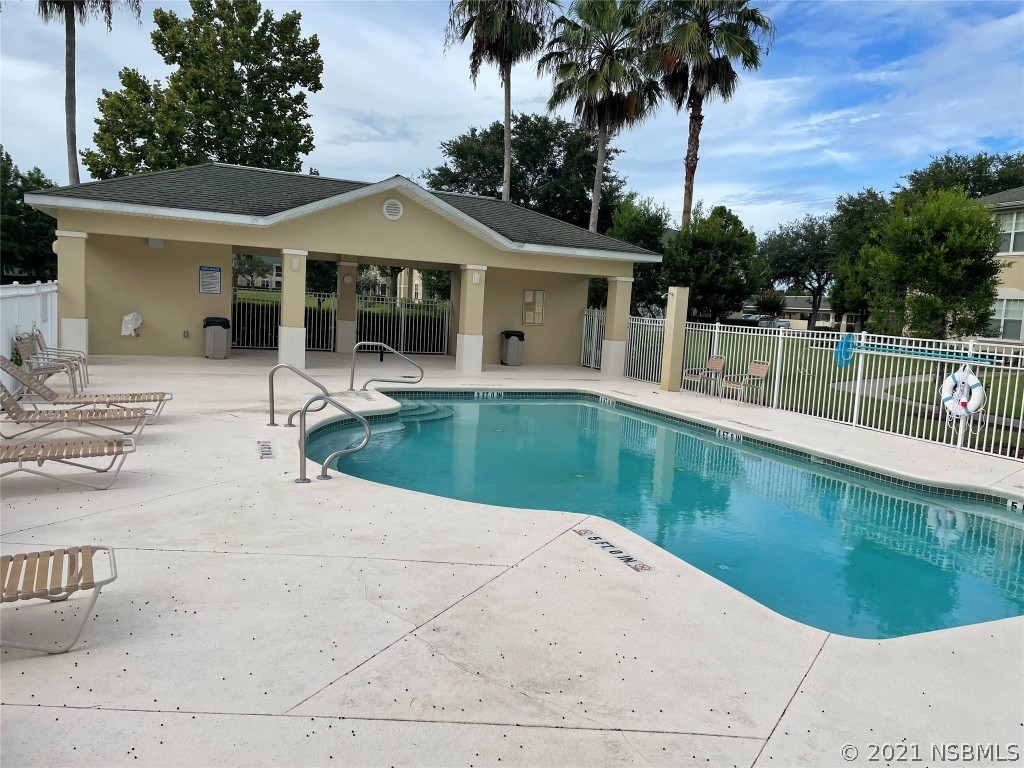 830 Airport Road, Unit 202 Port Orange, FL 32128 - Photo 2 of 35 a house view with a swimming pool and porch