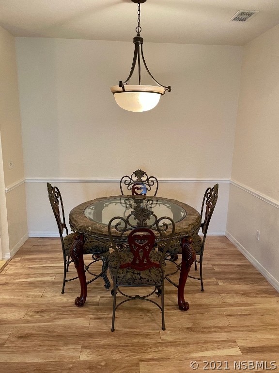 830 Airport Road, Unit 202 Port Orange, FL 32128 - Photo 21 of 35 a view of a dining room with furniture and wooden floor