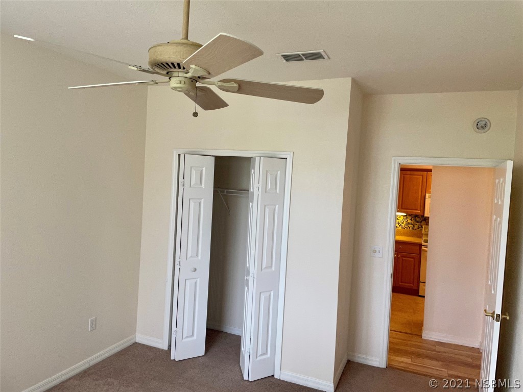 830 Airport Road, Unit 202 Port Orange, FL 32128 - Photo 28 of 35 a view of a livingroom with a ceiling fan and closet area