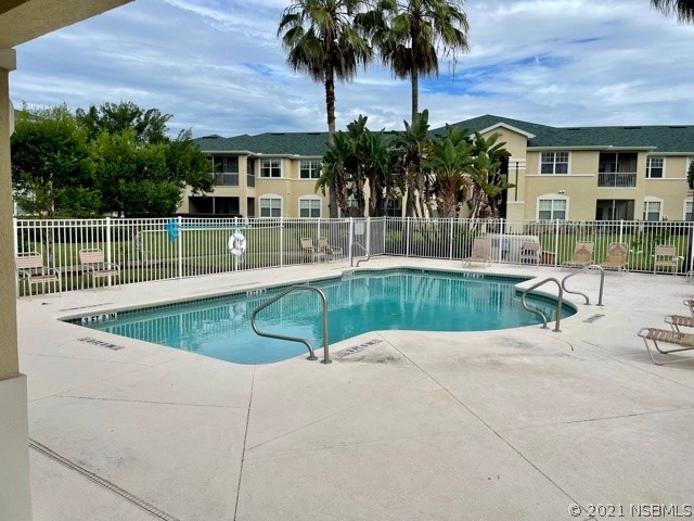 830 Airport Road, Unit 202 Port Orange, FL 32128 - Photo 3 of 35 a view of a swimming pool with a patio