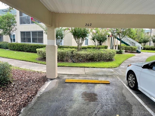 830 Airport Road, Unit 202 Port Orange, FL 32128 - Photo 8 of 35 a view of a house with a yard