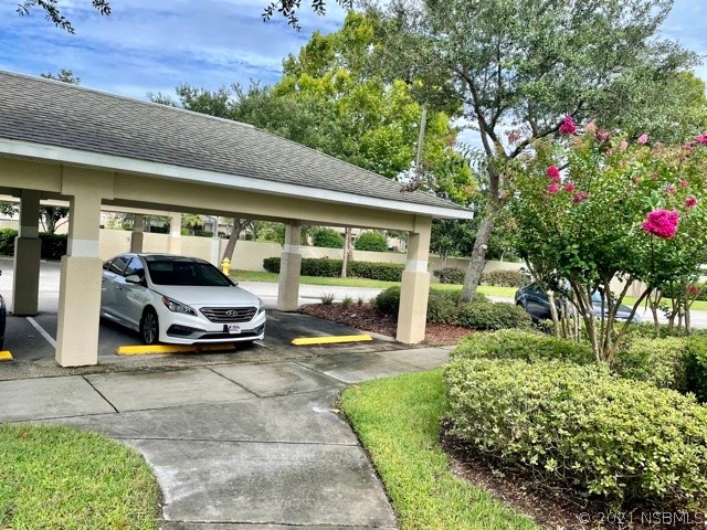 830 Airport Road, Unit 202 Port Orange, FL 32128 - Photo 9 of 35 a front view of a house with garden