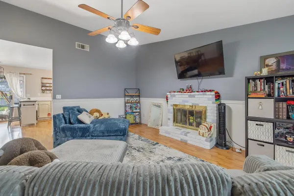a living room with furniture and a wooden floor