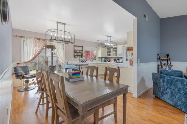 a view of a livingroom with wooden floor and a bedroom