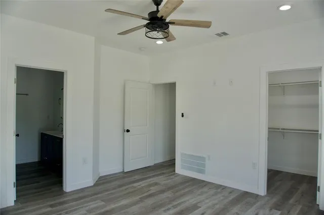 a view of an empty room with wooden floor