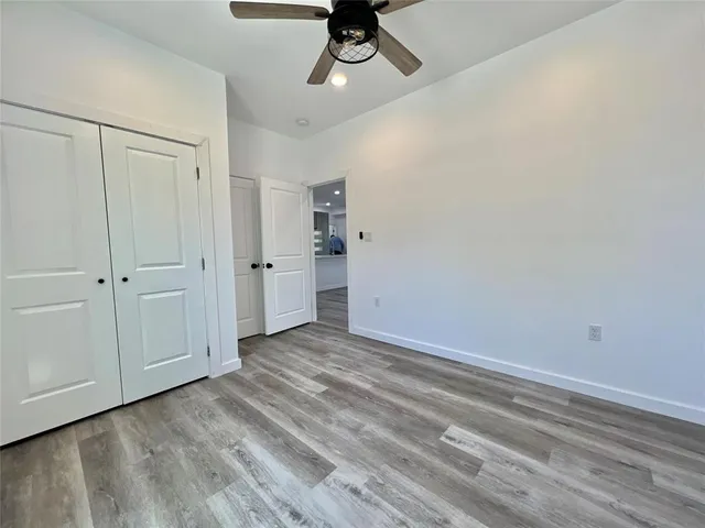 a view of empty room with ceiling fan