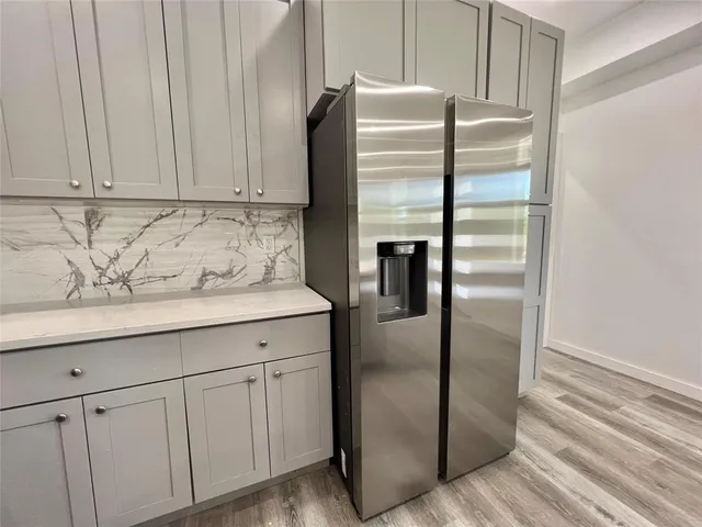 a kitchen with cabinets and stainless steel appliances