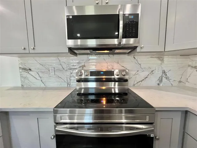 a stove top oven sitting inside of a kitchen