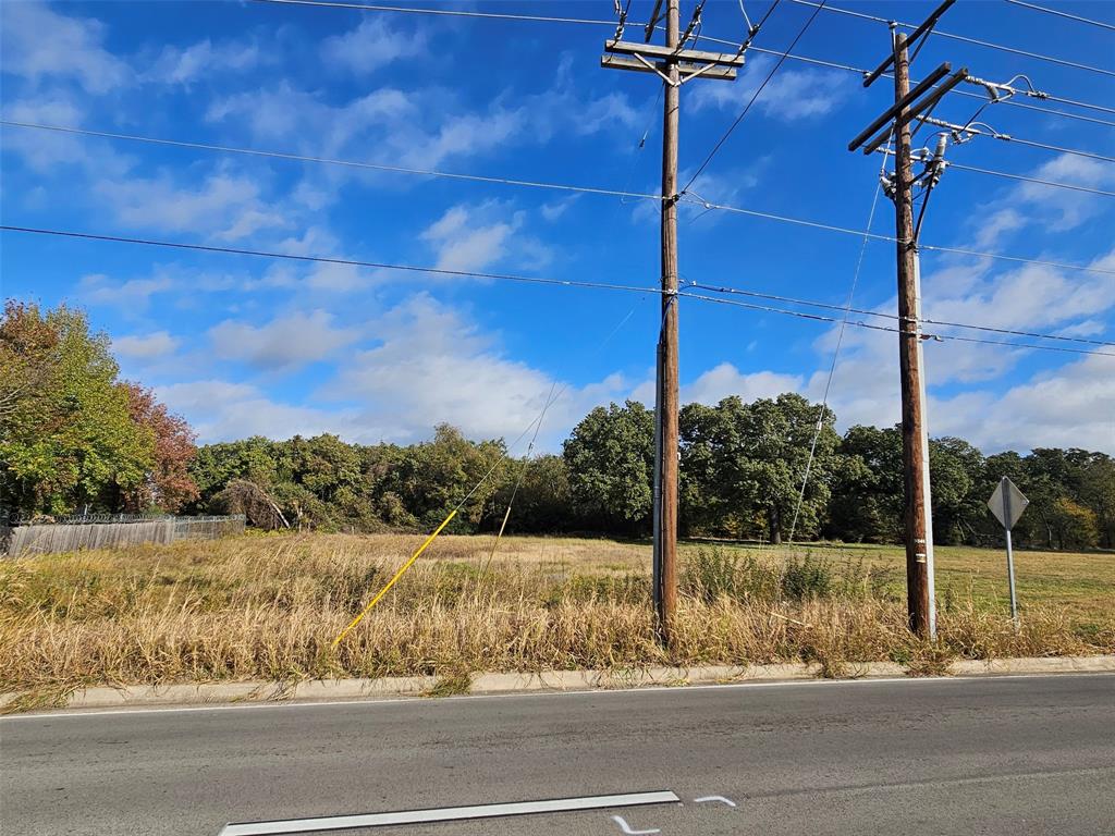 7609 John T White Road Fort Worth, TX 76120 - Photo 1 of 4 View of asphalt road with traffic signs and curbs