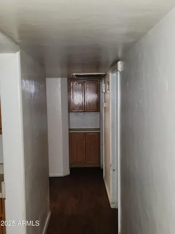 a view of hallway with cabinets