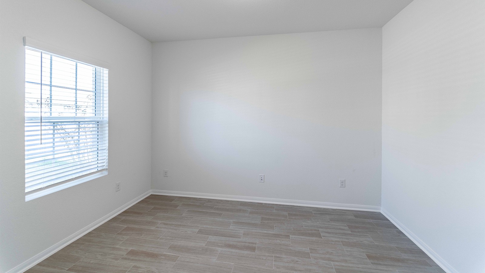 13621 Endless Narrow Lane Elgin, TX 78621 - Photo 11 of 19 wooden floor in an empty room with a window