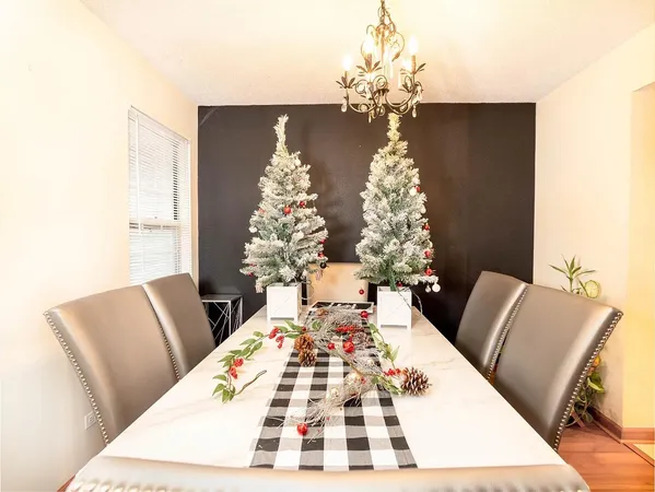 a view of a dining room with furniture and chandelier