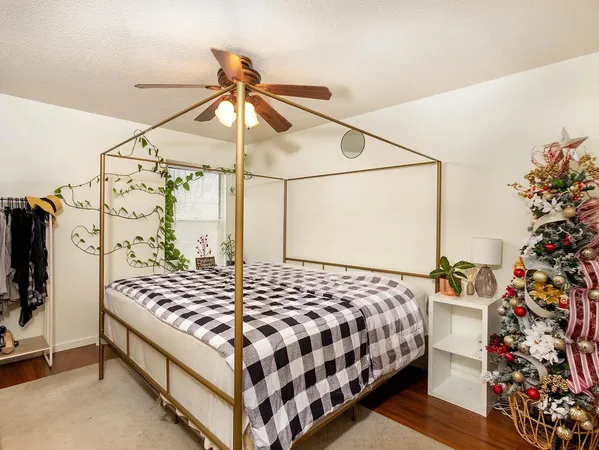 a bedroom with a bed and a chandelier