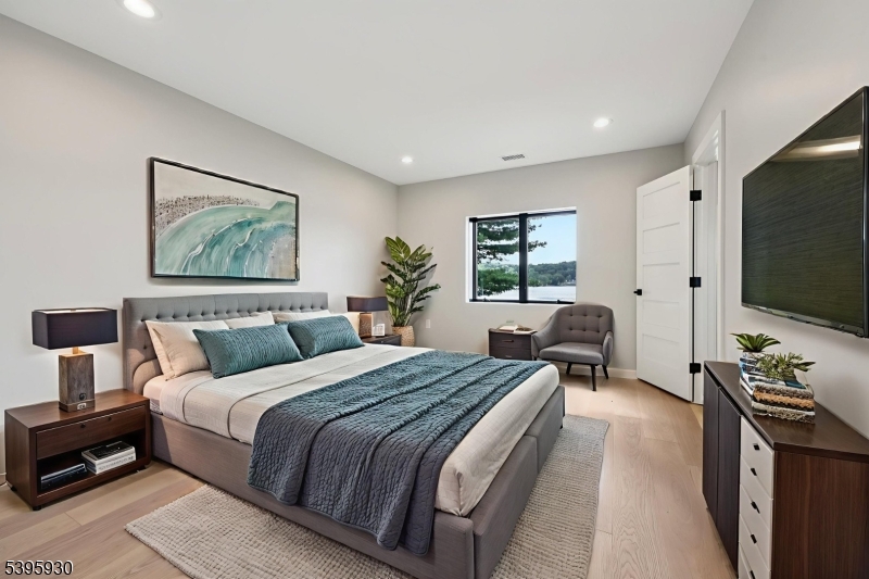 12 Rocky Point Road West Milford, NJ 07421 - Photo 27 of 50 a spacious bedroom with a large bed and a flat screen tv