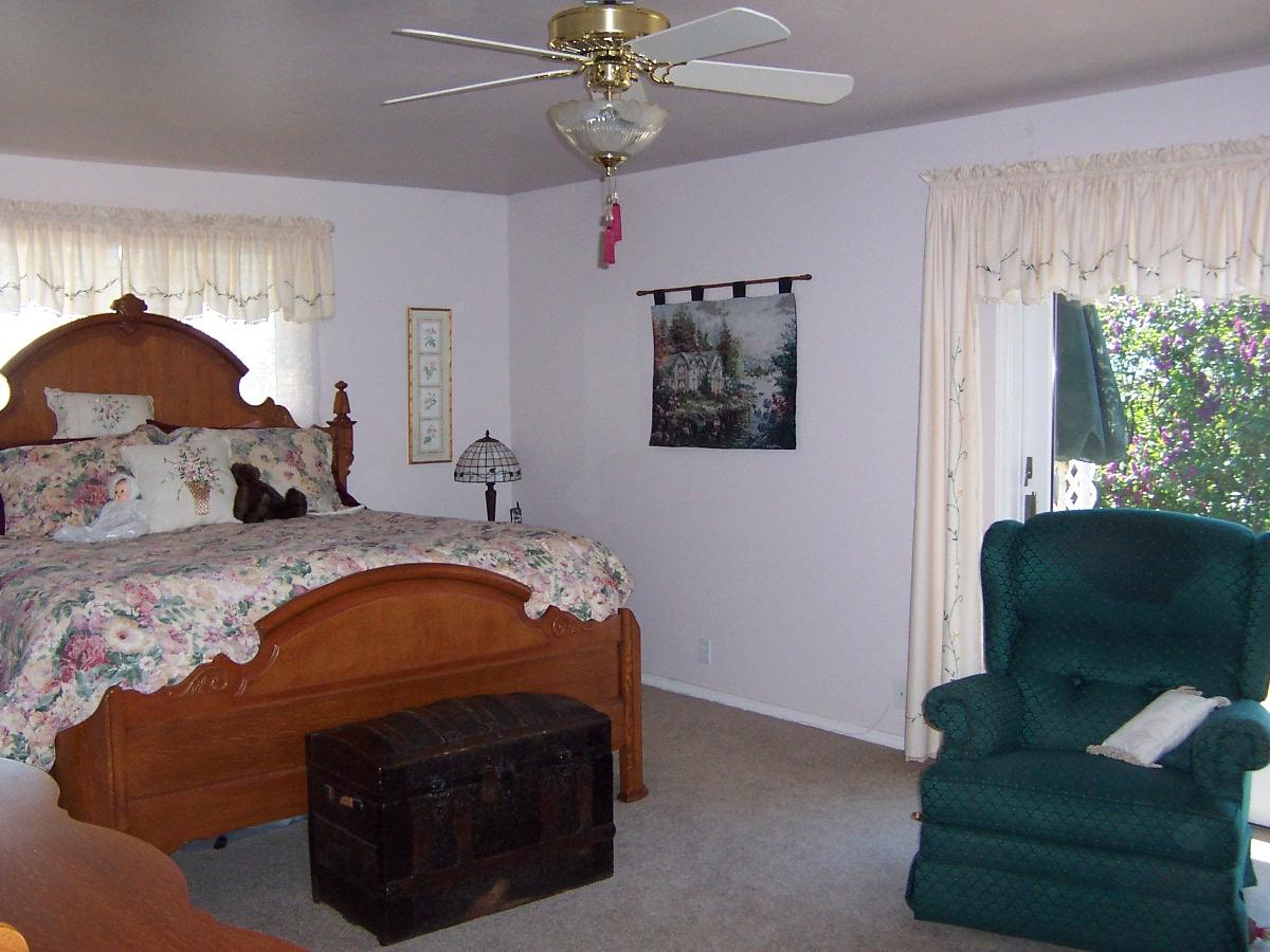 121 Arrowsmith Road Sunnyside, WA 98944 - Photo 9 of 13 a bed sitting in a bedroom next to a window and a chandelier